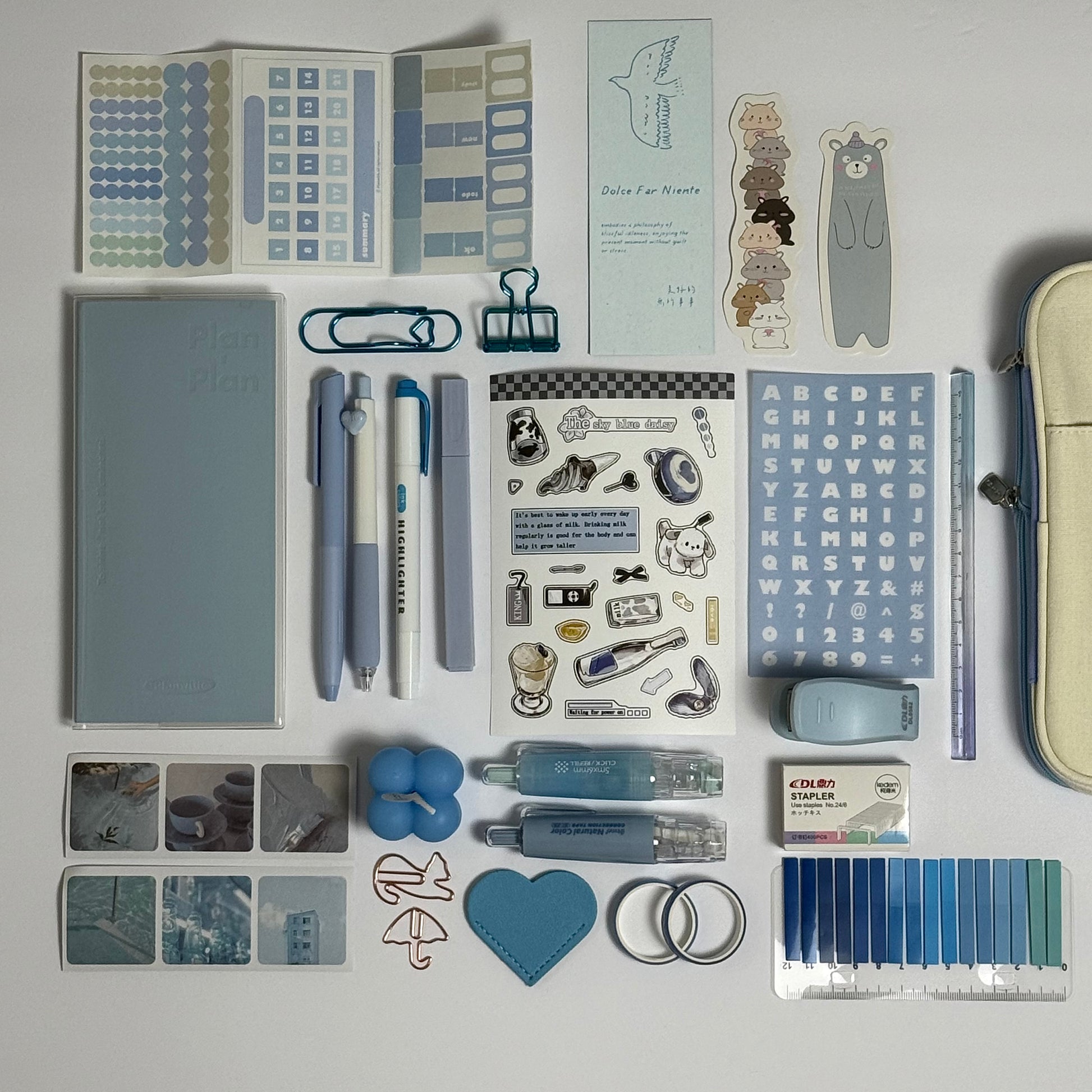 Blue stationery planner set flat lay with journal, pens and stickers